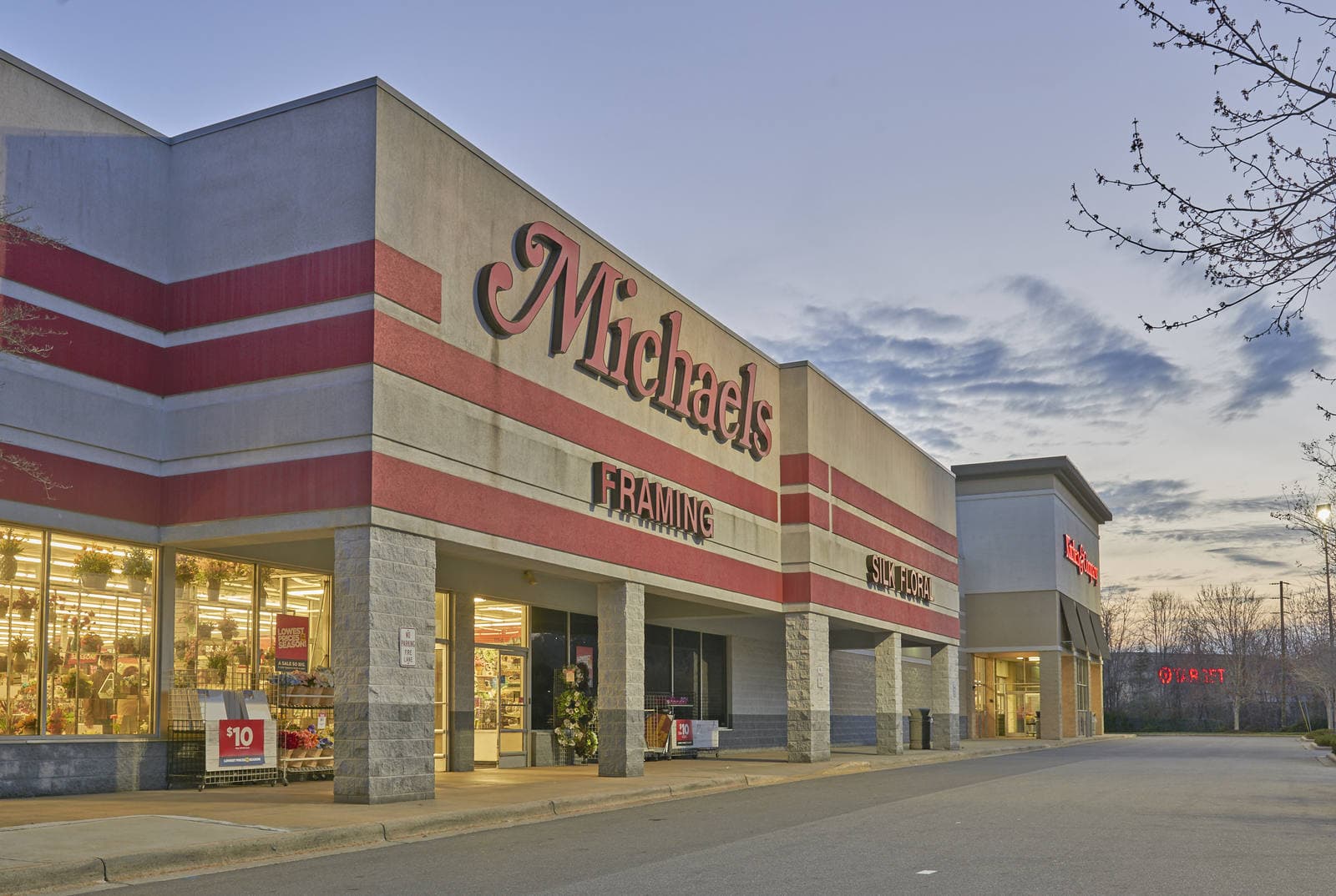 River Hills Shopping Center storefronts lit at dusk