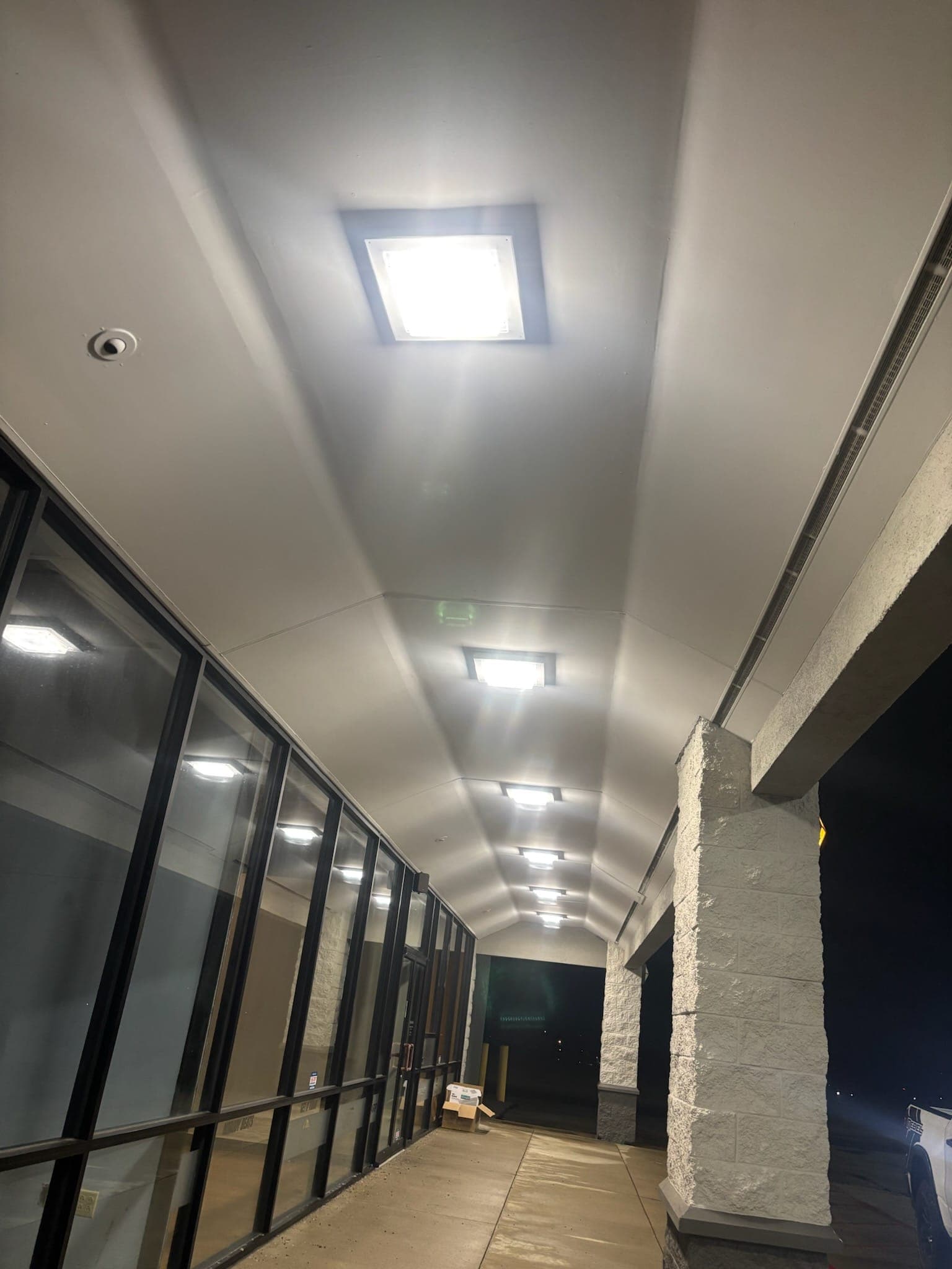 Summit Ridge Plaza covered storefront walkway lit at night